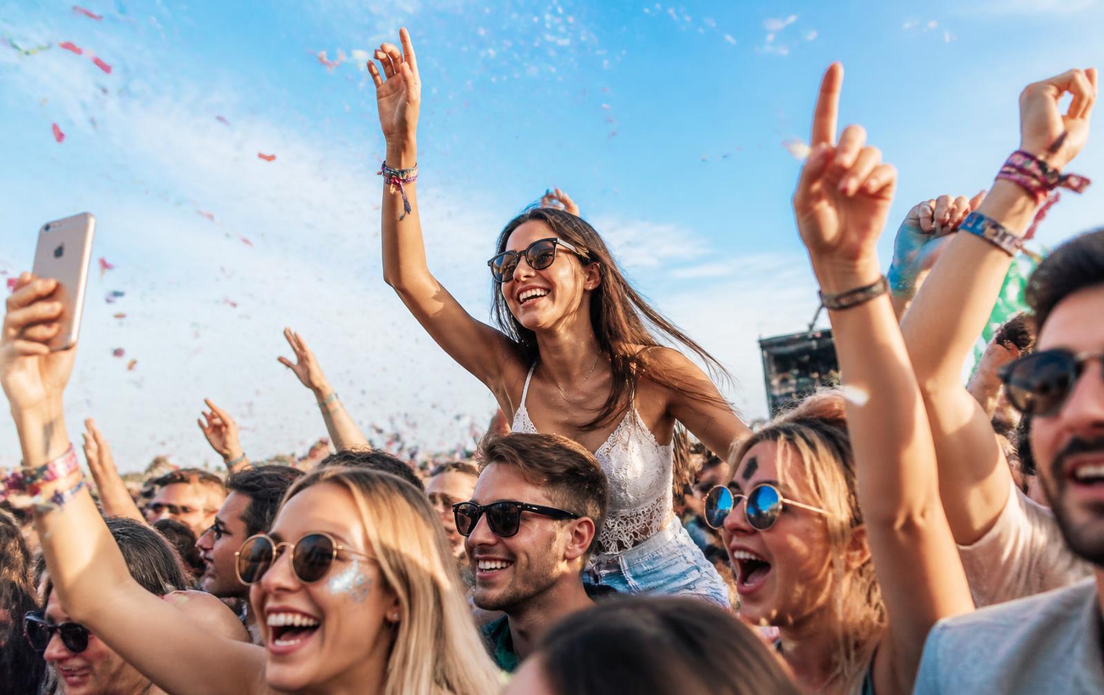Crowd buying UK event and club night tickets at a music festival